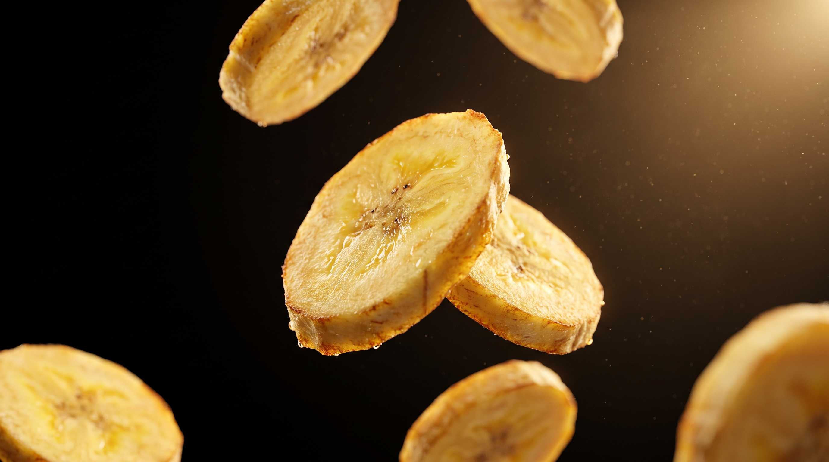 Macro close-up of a 1.2mm thin Kerala banana chip slice suspended in air